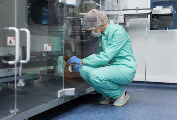 caucasian-factory-worker-blue-lab-suit-work-with-machine-squat 2