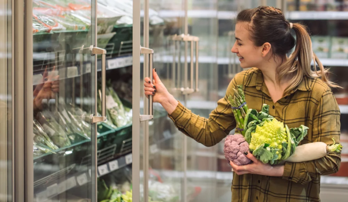 woman-supermarket-beautiful-young-woman-holds-hands-fresh-organic-vegetables-opens-fridge-supermarket-concept-healthy-eating-harvest 1